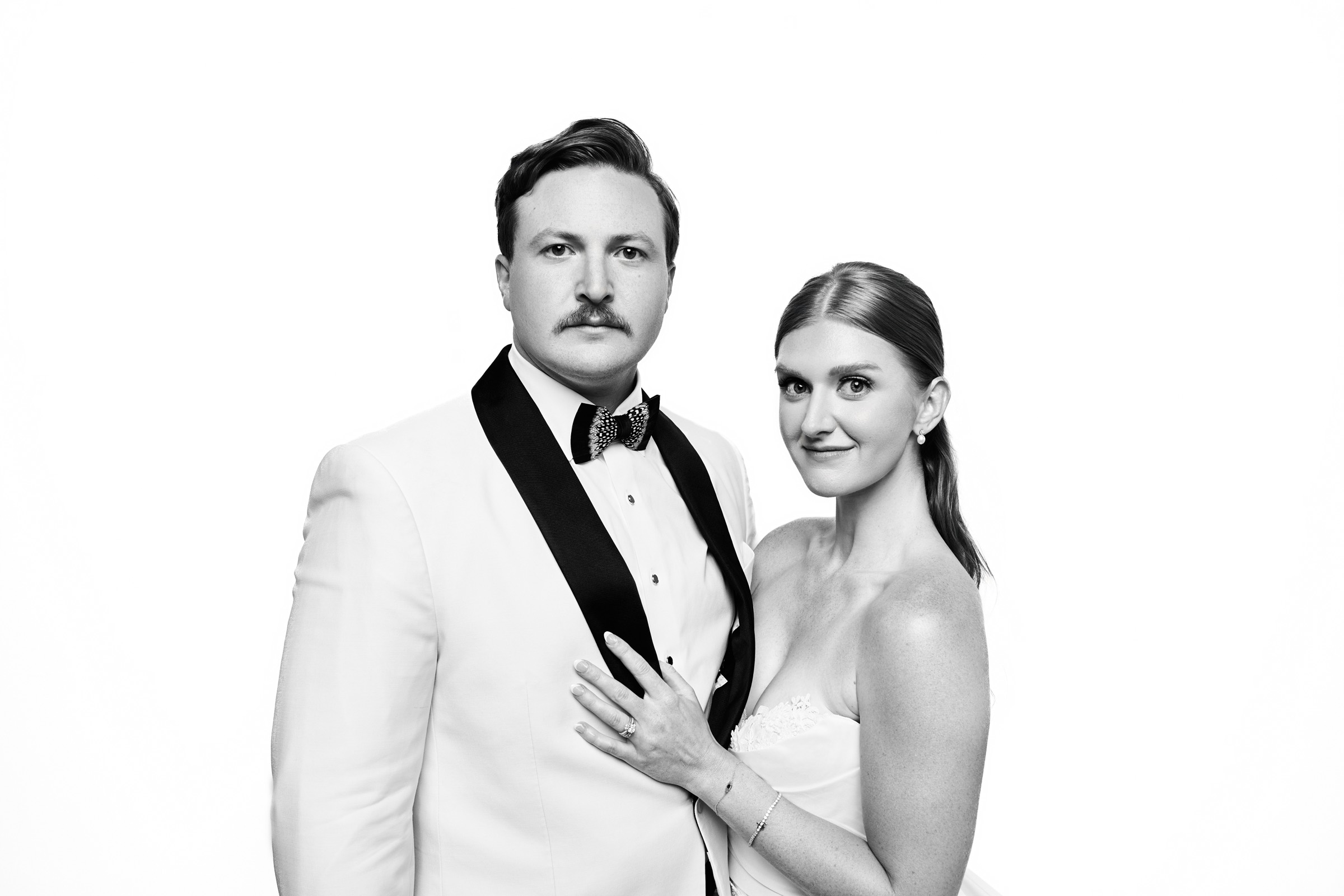 Bride and groom in a composed, editorial pose directed by the photographer